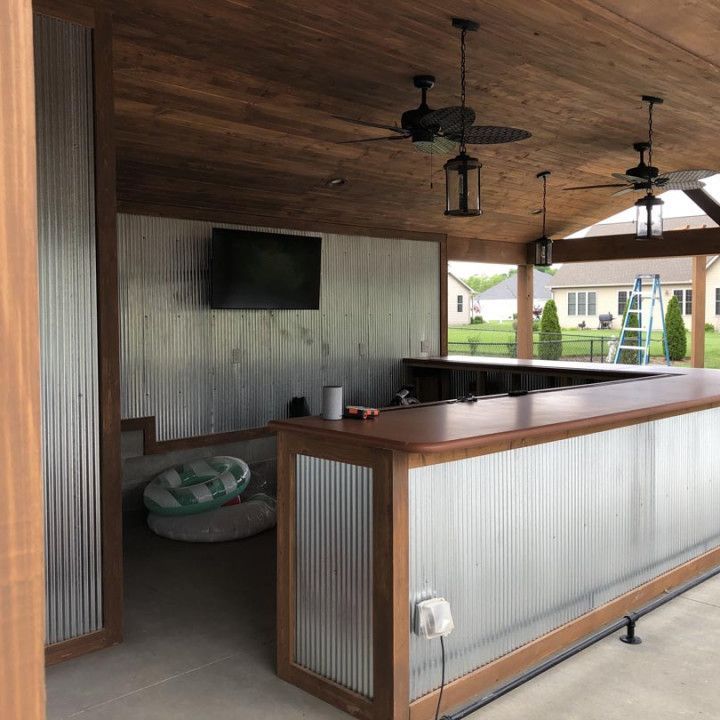 A room with a ceiling fan and a tv on the wall