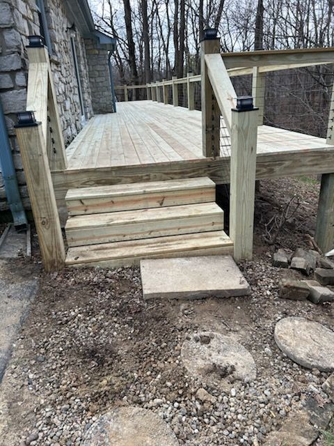 A wooden deck with stairs leading up to it.