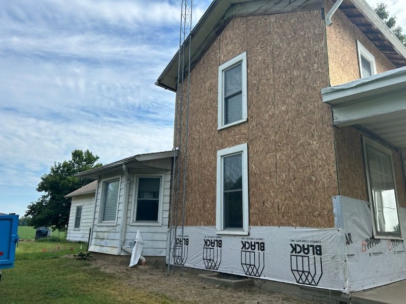 A house with a lot of windows is being remodeled.
