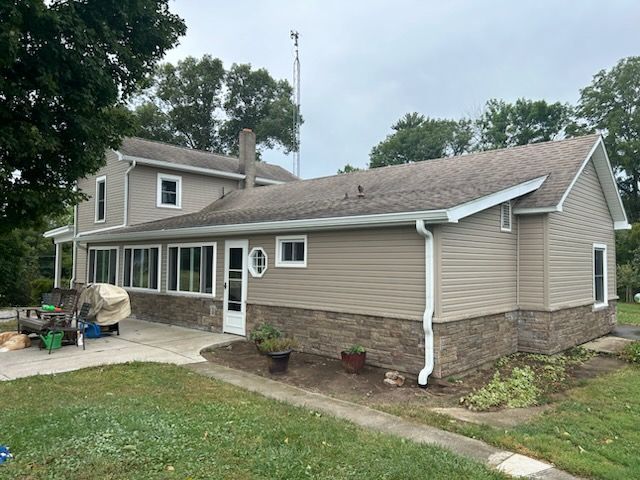 A large house with a lot of windows and a roof.