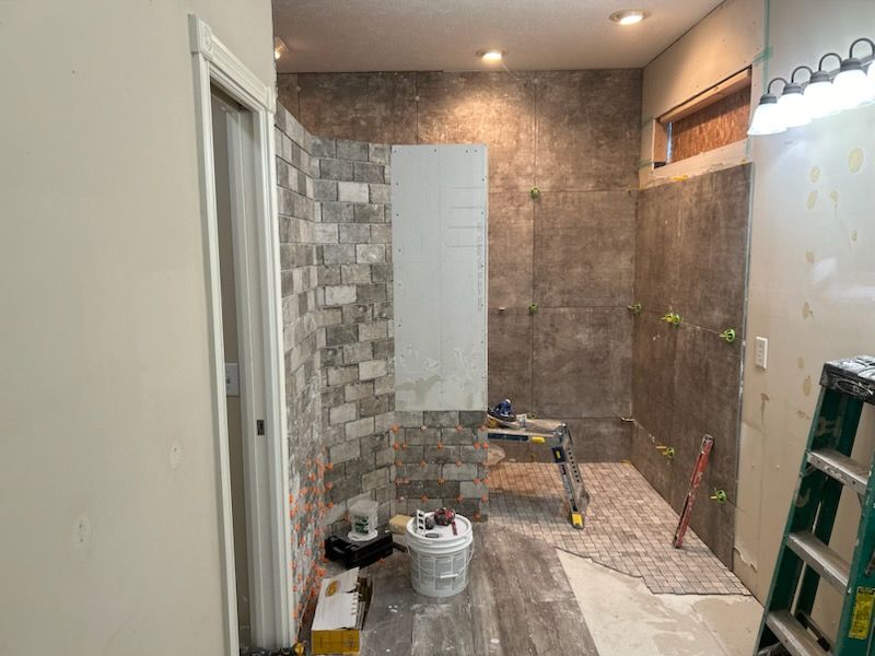 A bathroom under construction with a ladder and a toilet.
