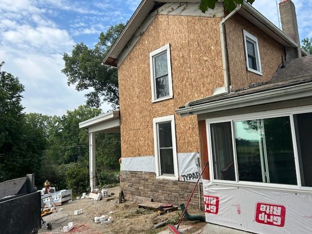 A house with a lot of windows is being remodeled.