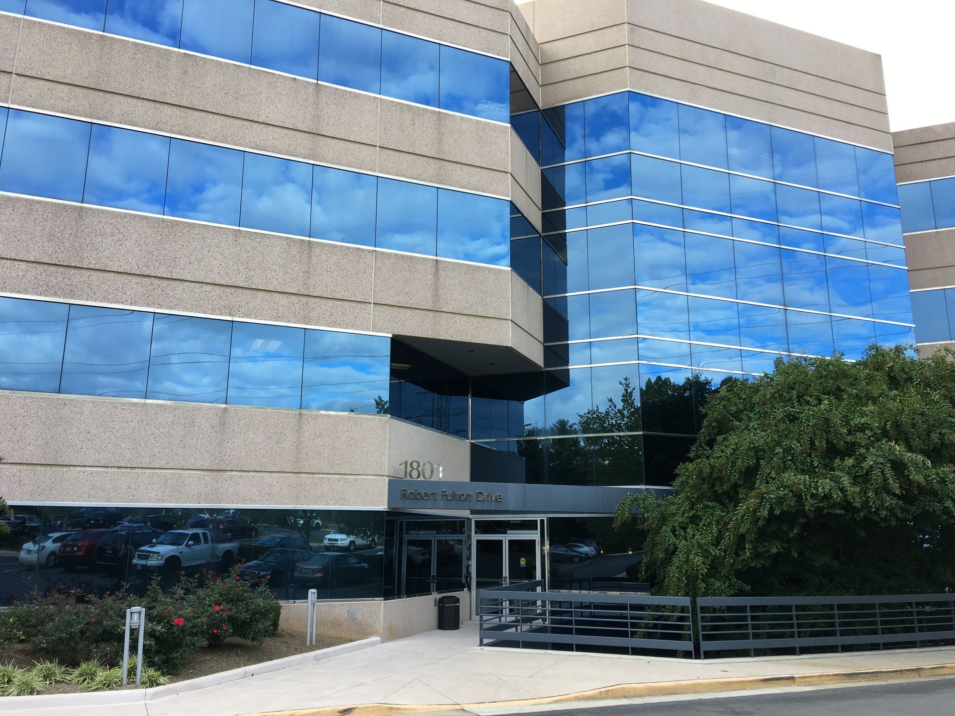 Woman in a bathroom with a towel on her head, flossing her teeth.