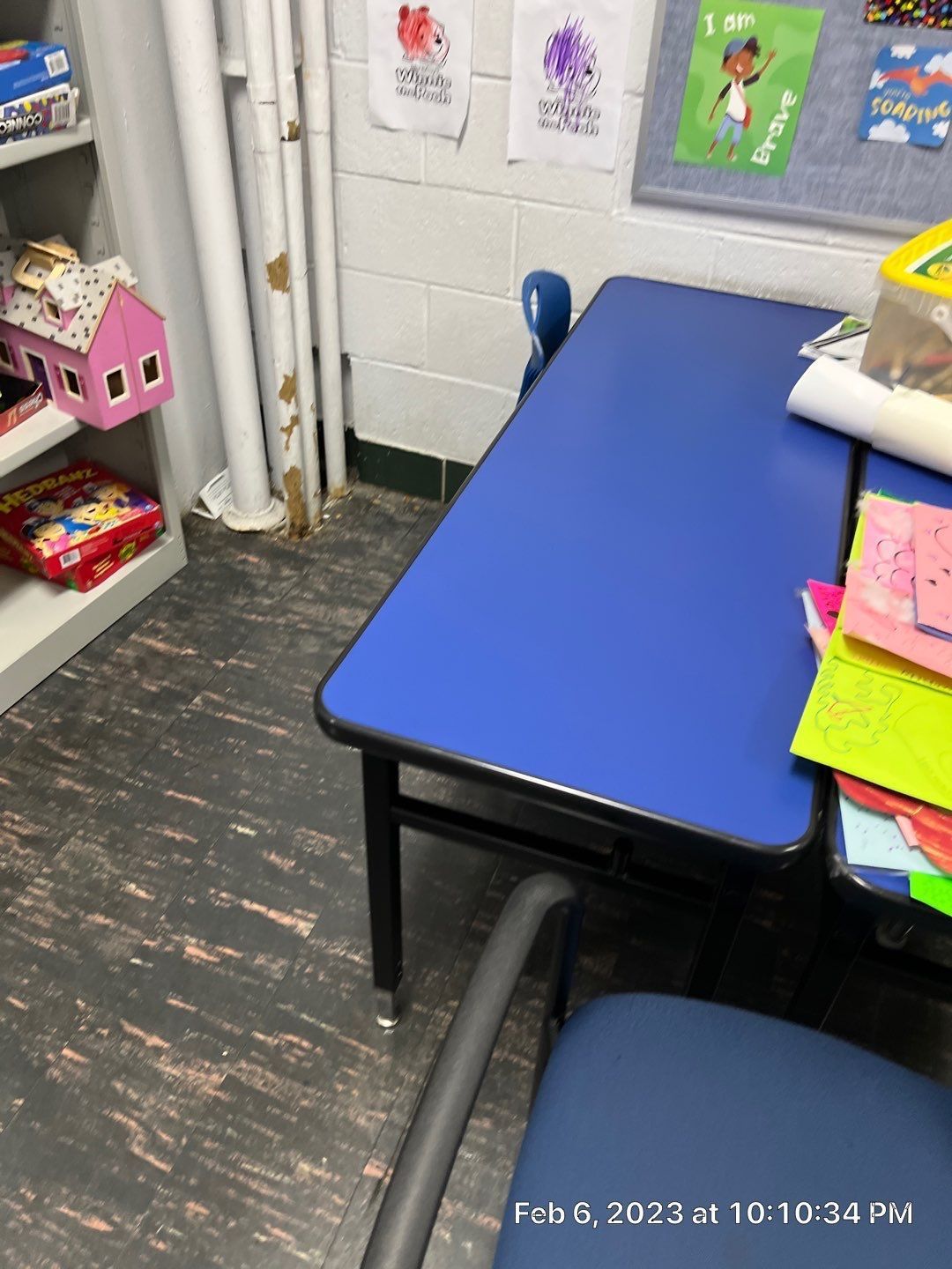 A blue desk and chair in a classroom on february 8th