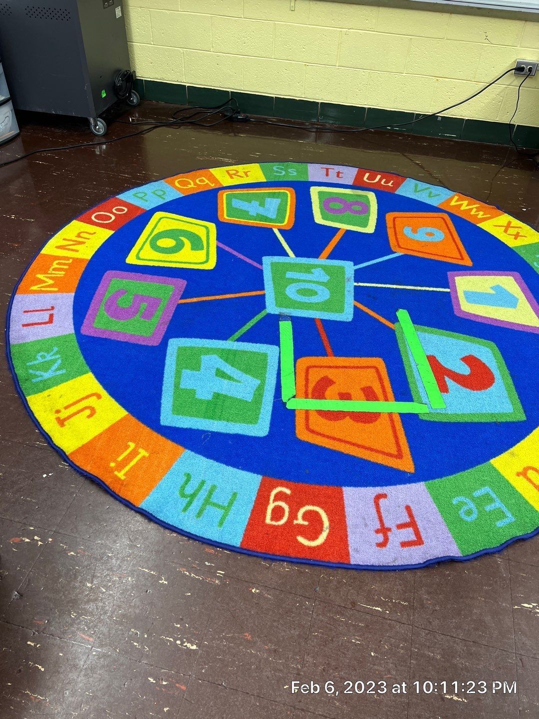 A colorful rug with letters and numbers on it