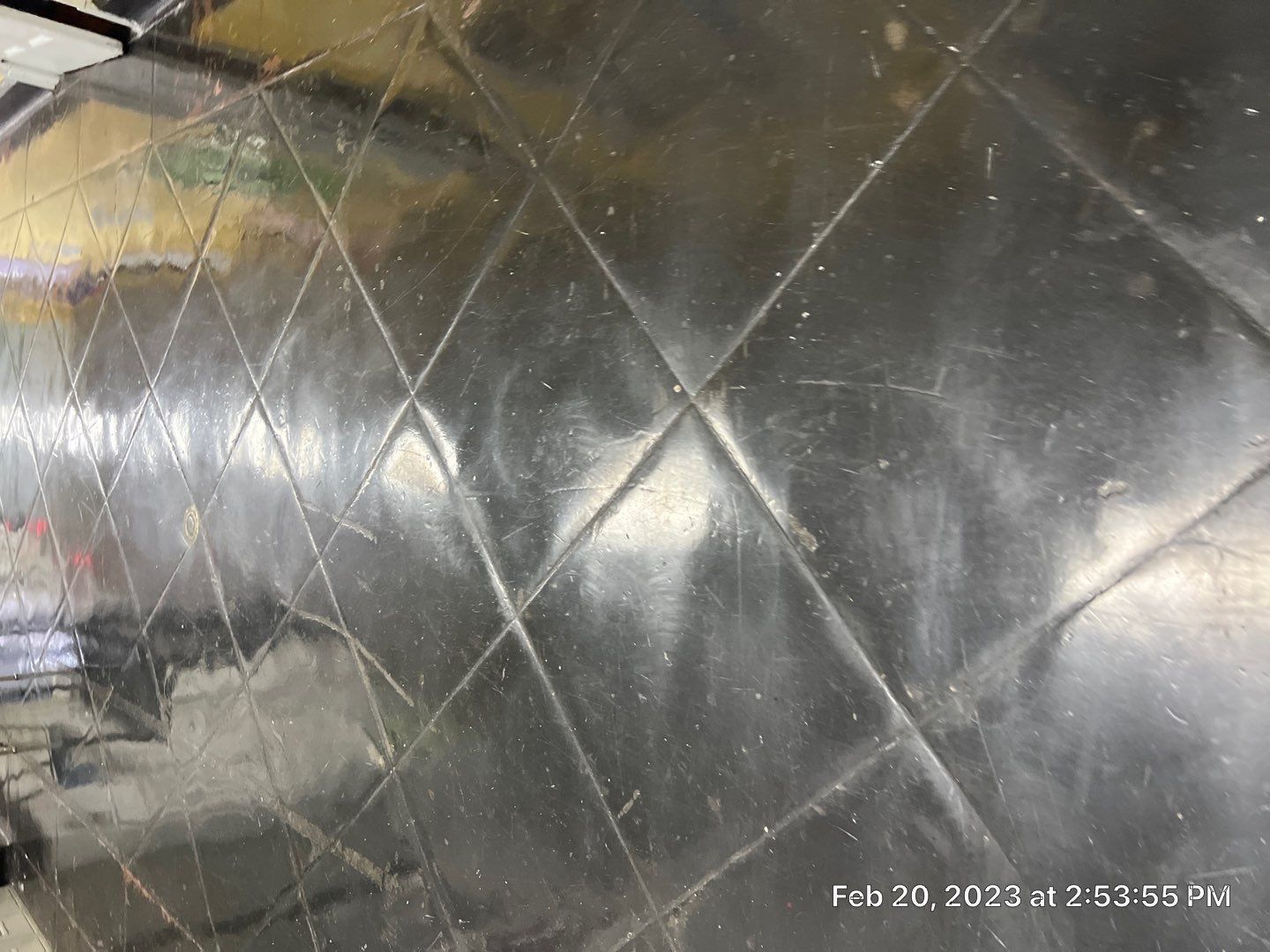 A close up of a black tile floor with a grid pattern.