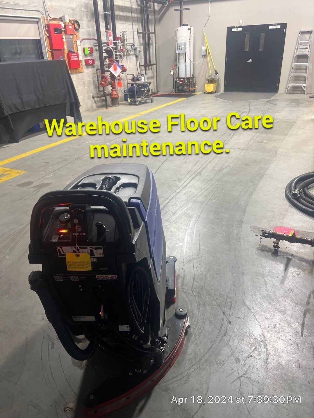 A warehouse floor care machine is sitting in a warehouse