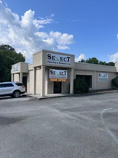 Exterior view of a Select Hemp & Botanical Store. Beige building with black lettering and a 