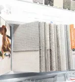 Carpet sample display: various neutral-toned carpet swatches with information about pet-friendly features.