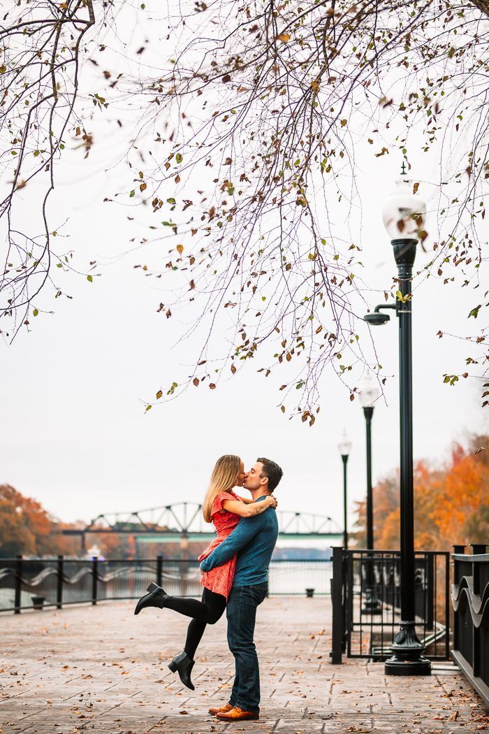 A man is holding a woman in his arms and kissing her.