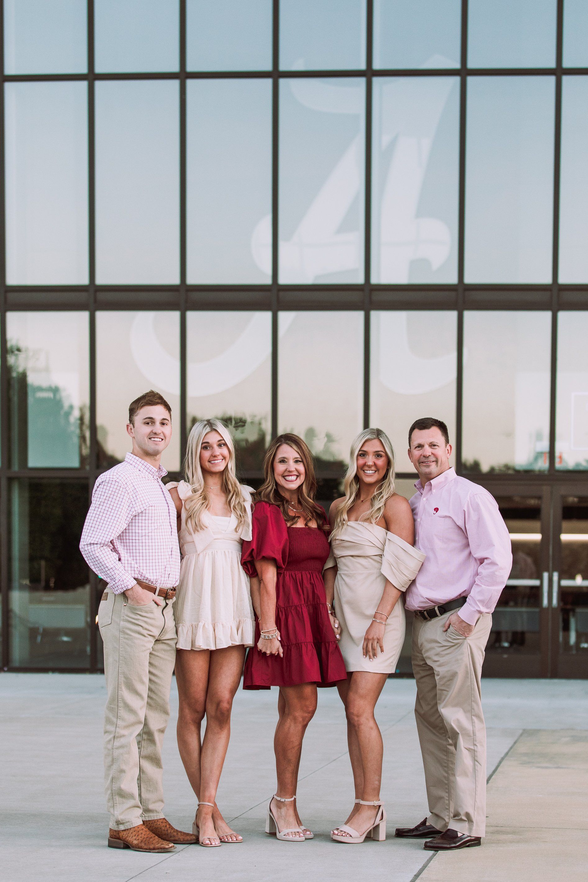 A group of people are posing for a picture in front of a building.