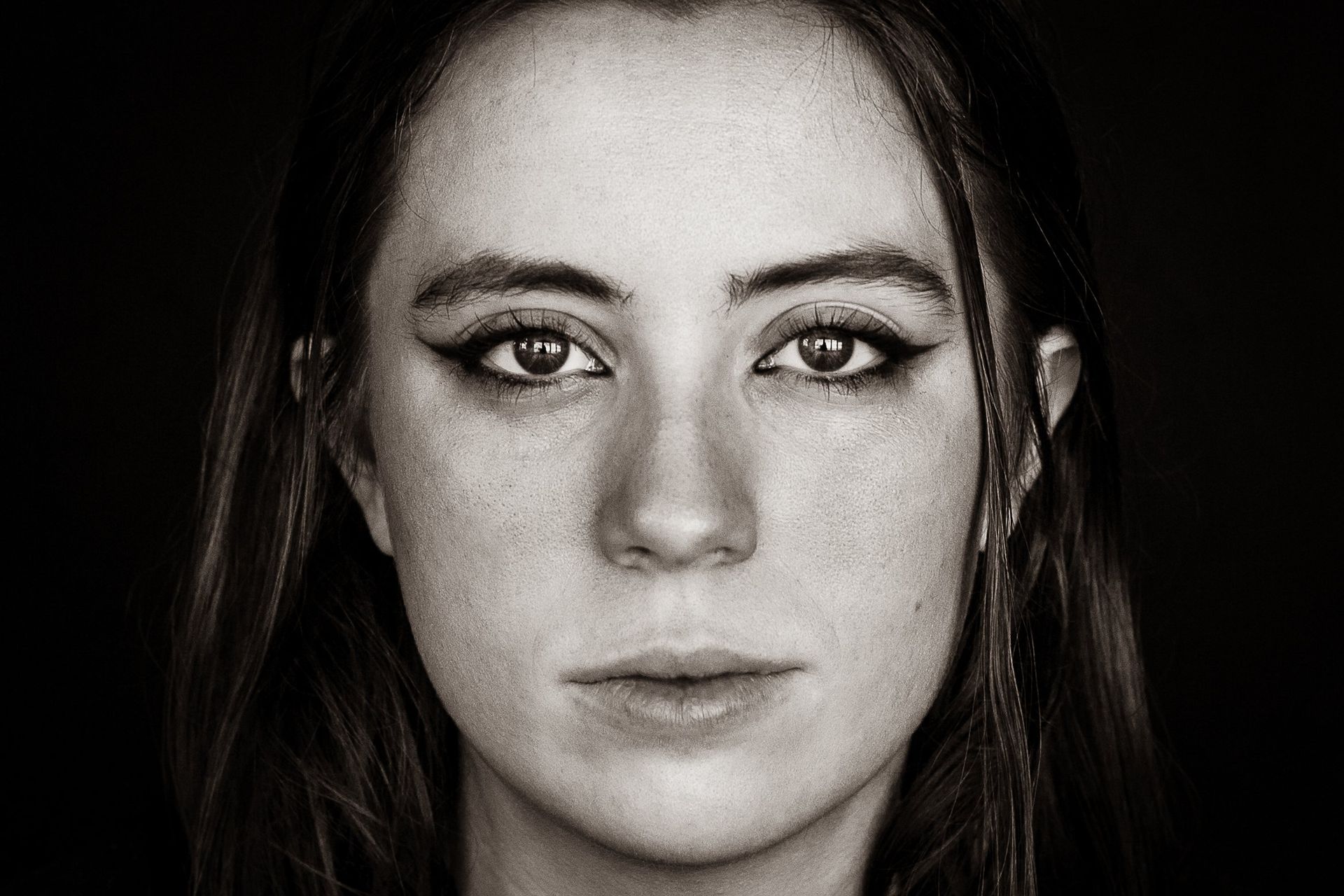 A close up of a woman 's face in a black and white photo.