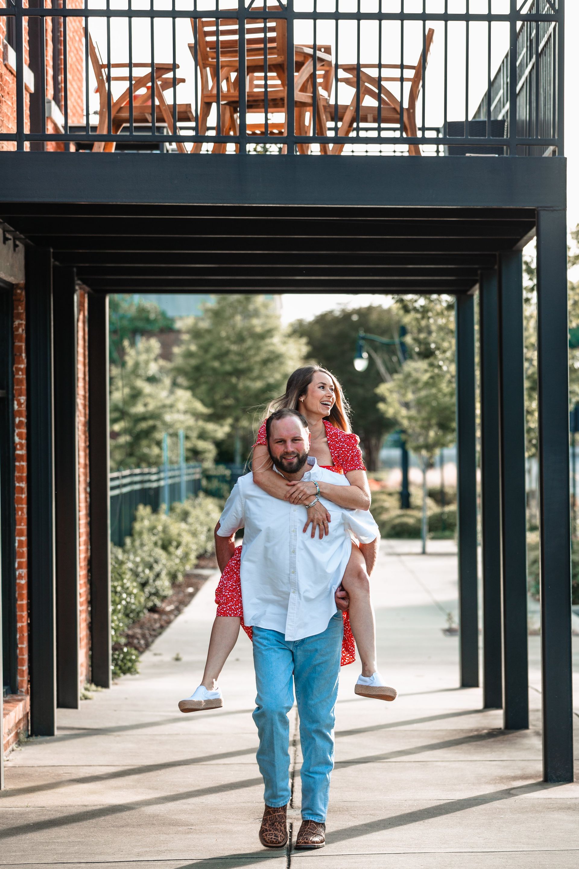 A man is carrying a woman on his back through a tunnel.