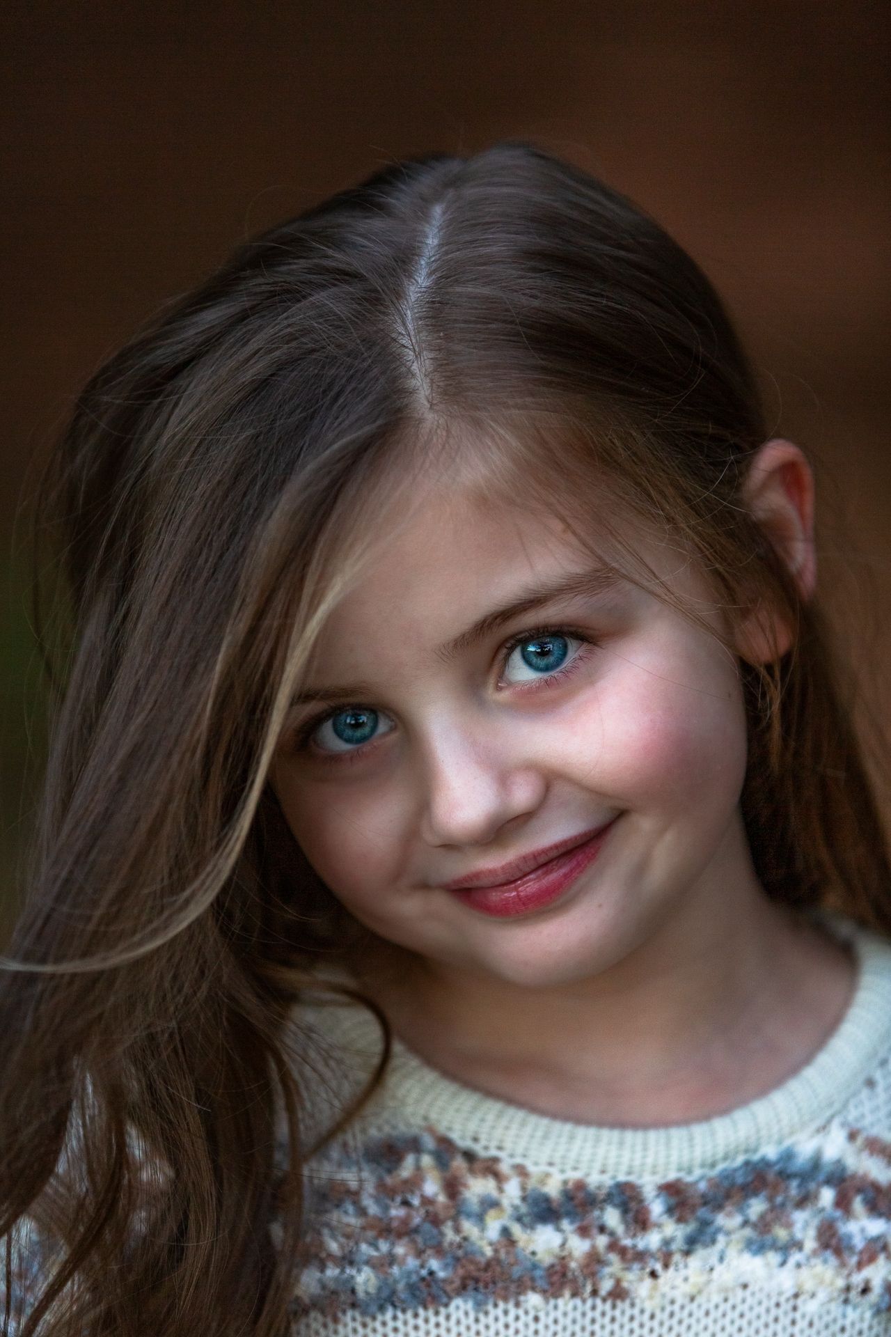 A little girl is smiling at the camera.