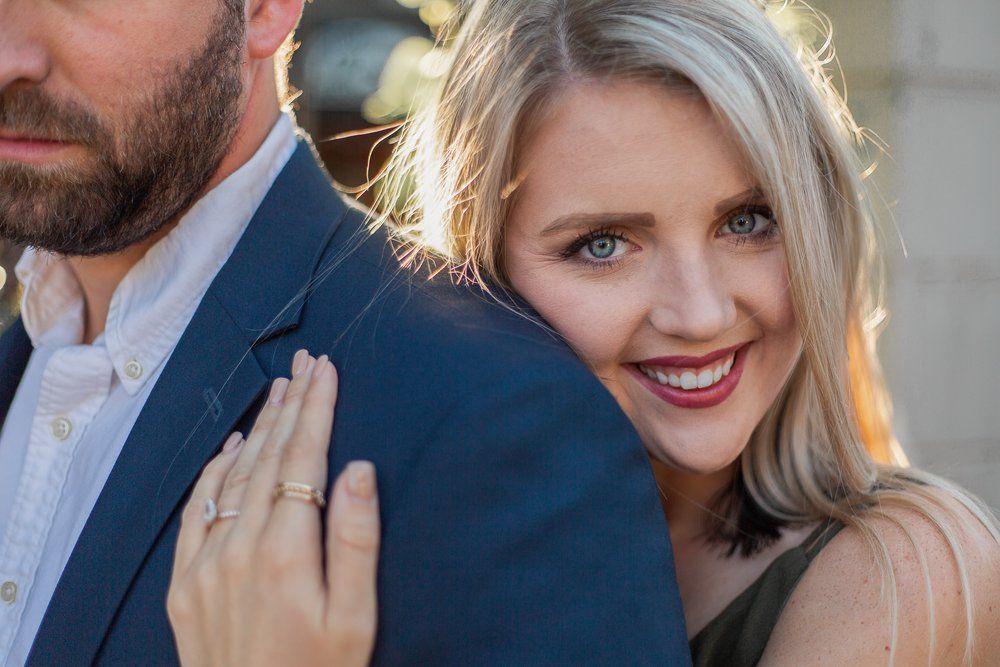 A woman is putting her hand on a man 's shoulder.