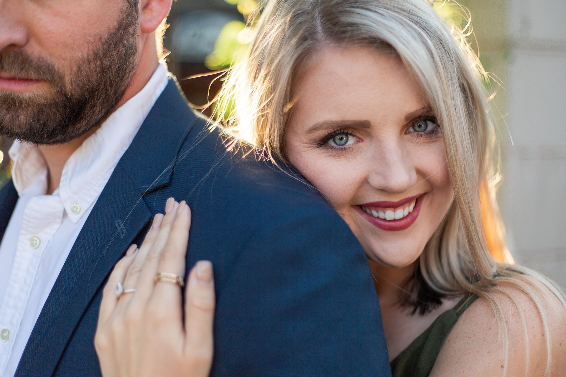 A woman is putting her hand on a man 's shoulder.