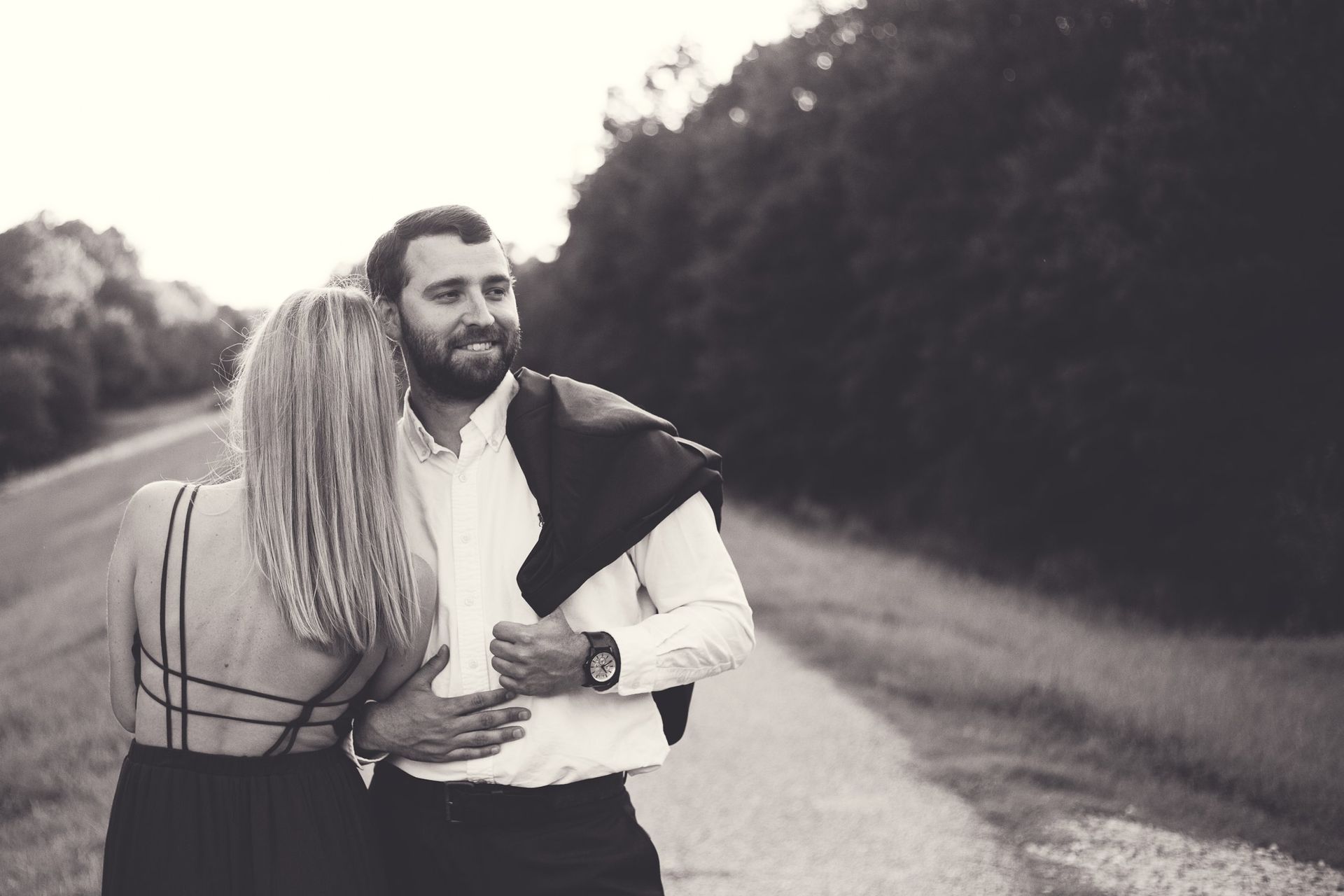 A man and a woman are standing next to each other on a road.