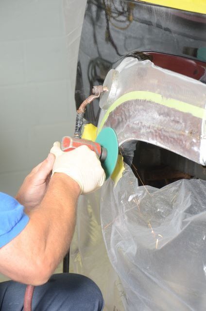 Man Repairing a Car Dent — Auto Repair in Braintree,, MA