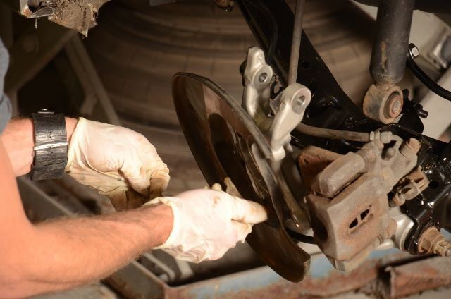 Man Replacing a Car Break — Auto Repair in Braintree,, MA