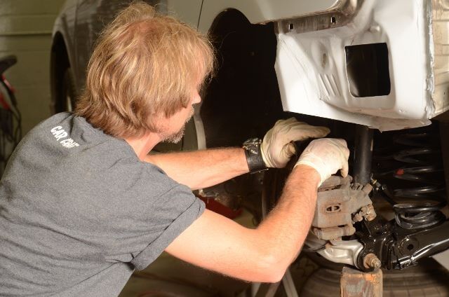 Man Repairing a Car Break — Auto Repair in Braintree,, MA