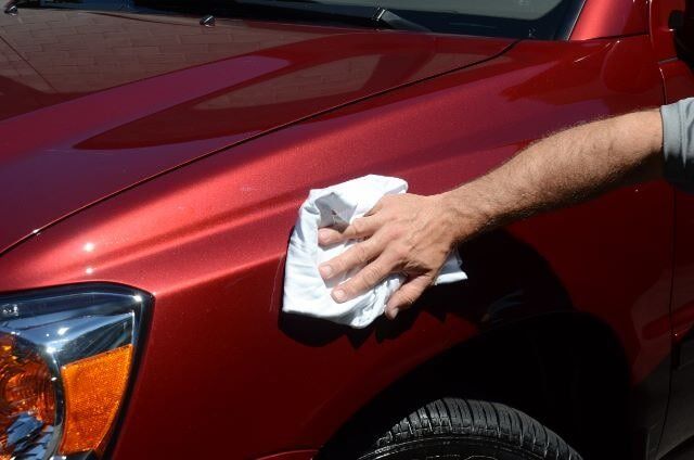Man Wiping a Cloth to Clean a Car — Auto Repair in Braintree,, MA