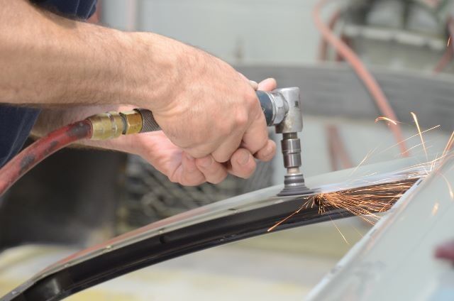 Man Trimming a Metal — Auto Repair in Braintree,, MA