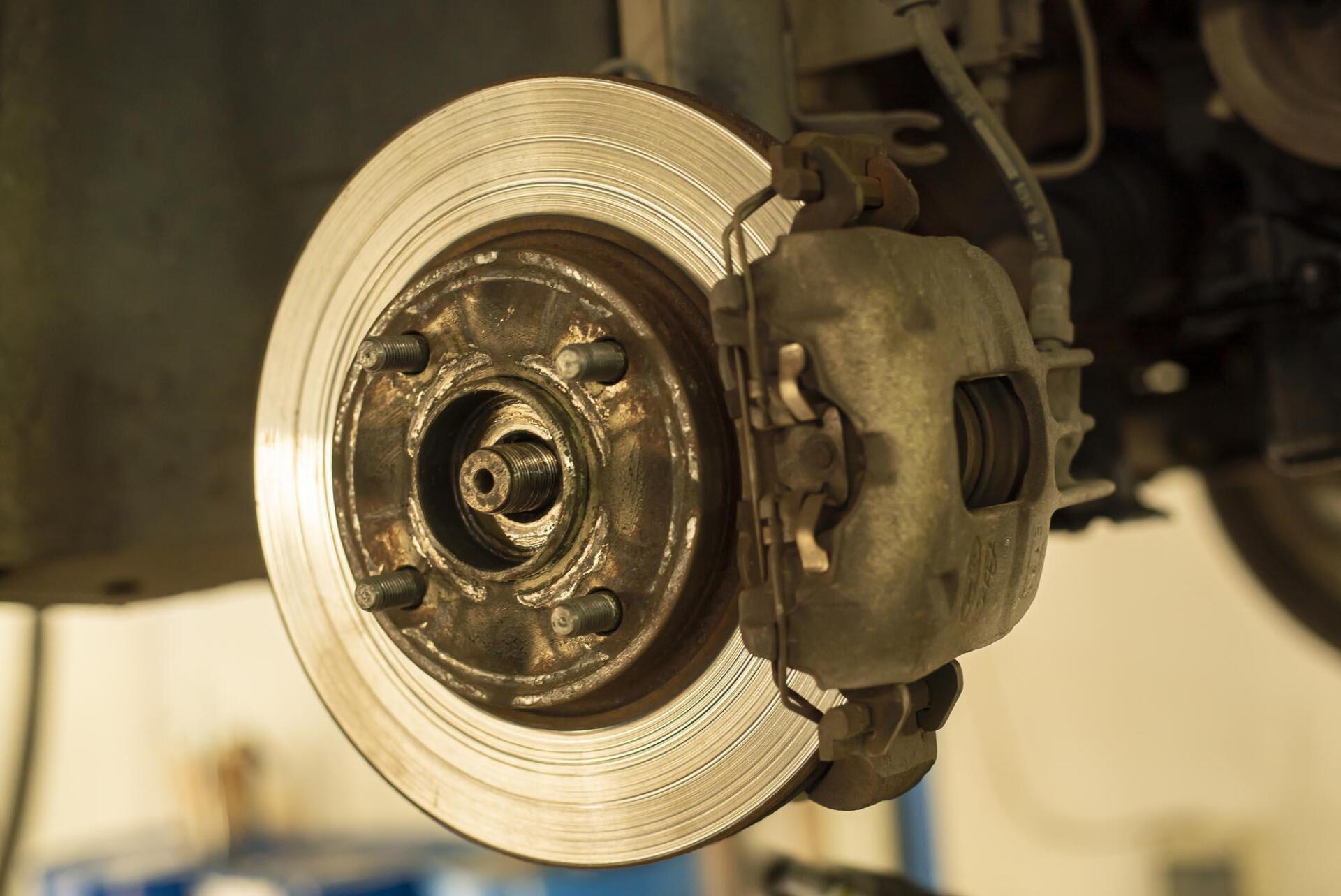 A close up of a brake disc on a car.