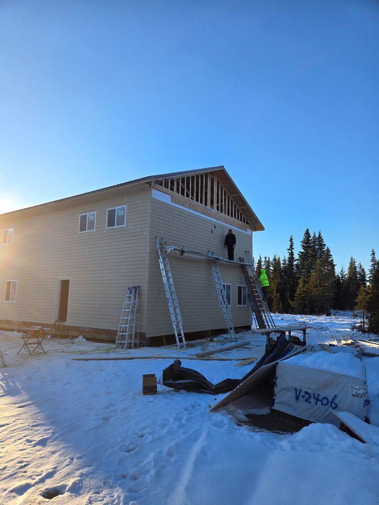 A large house is being built in the snow.