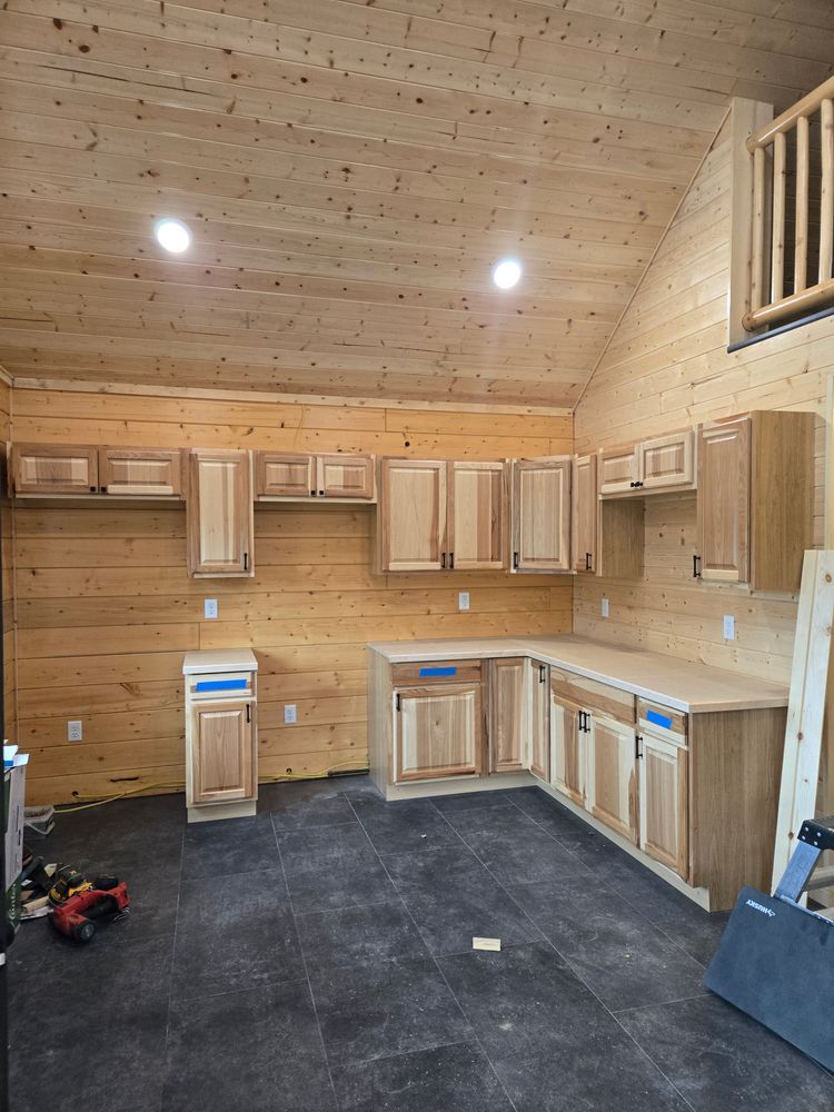 A kitchen with wooden cabinets and a wooden ceiling