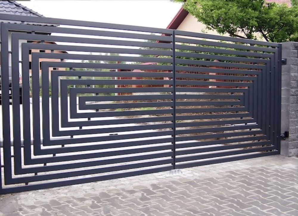 Dark gray metal driveway gate with geometric, horizontal lines.