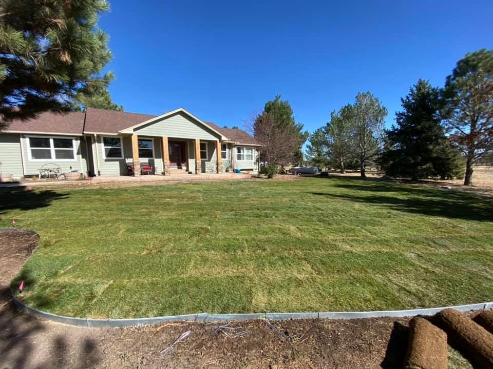 A house with a large lawn in front of it