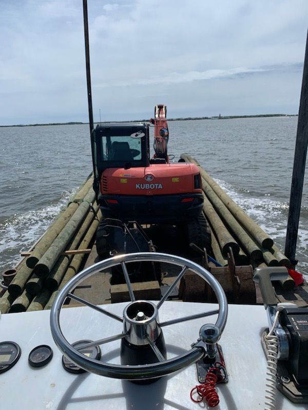 A boat with a steering wheel and a tractor on it