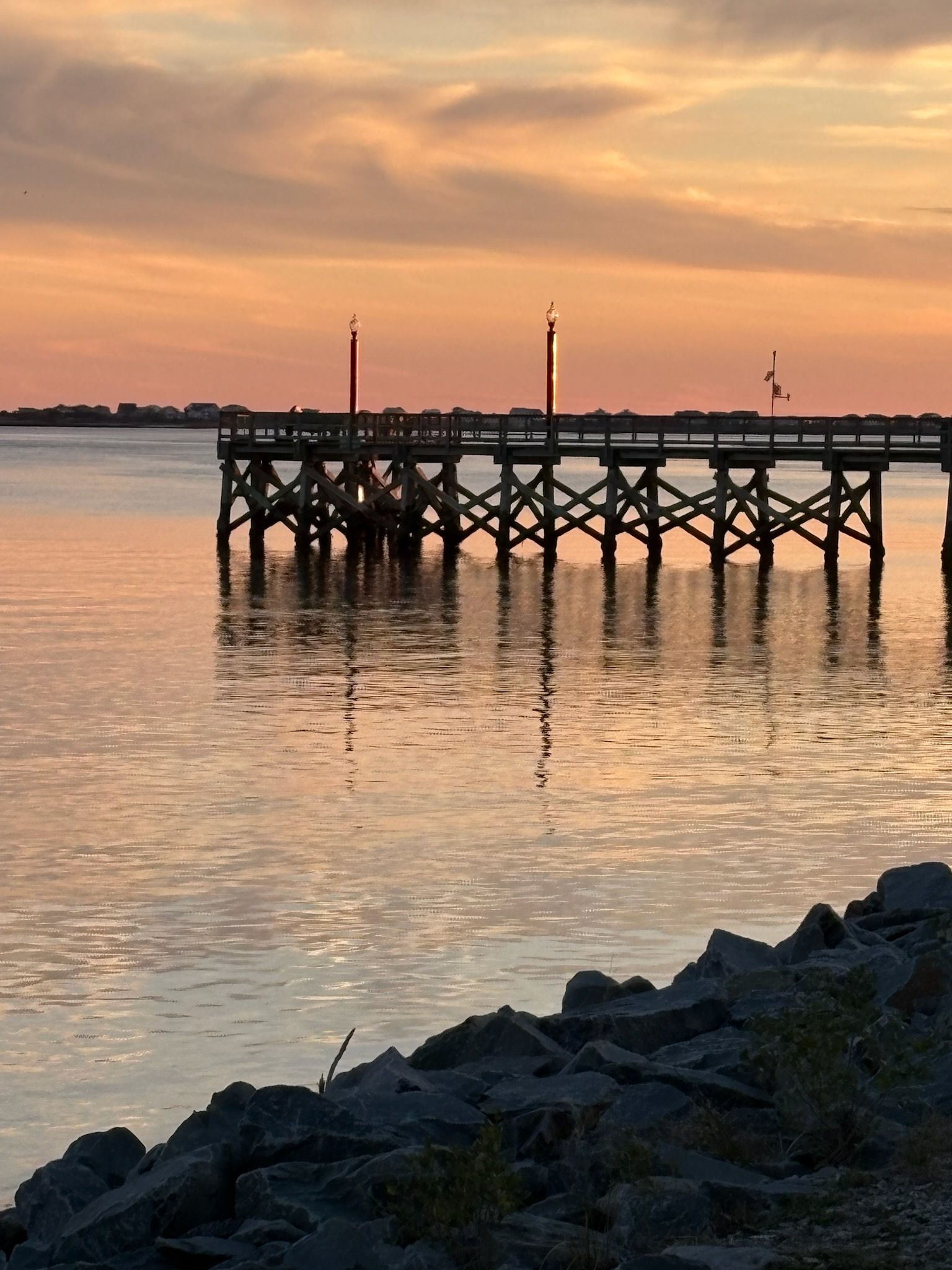 A pier overlooking a body of water at sunset.