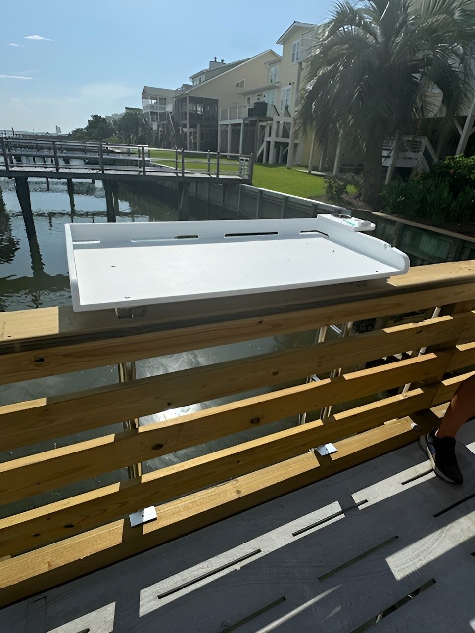 A wooden deck overlooking a body of water.