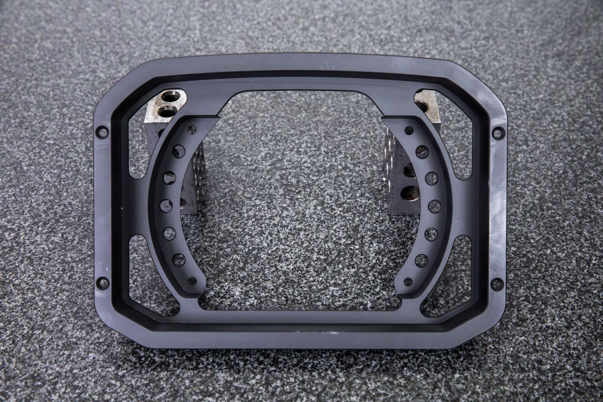A black billet dash mount bezel made by Precision Metal Craft for an AiM MXG 1.3.