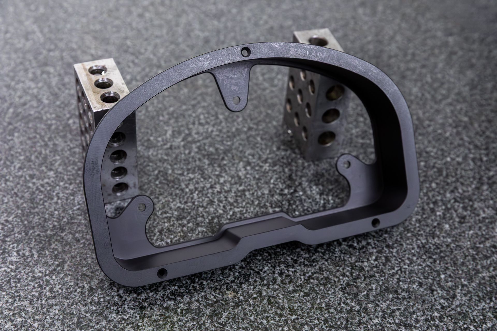 A black billet dash mount bezel made by Precision Metal Craft for a Racepak IQ3.