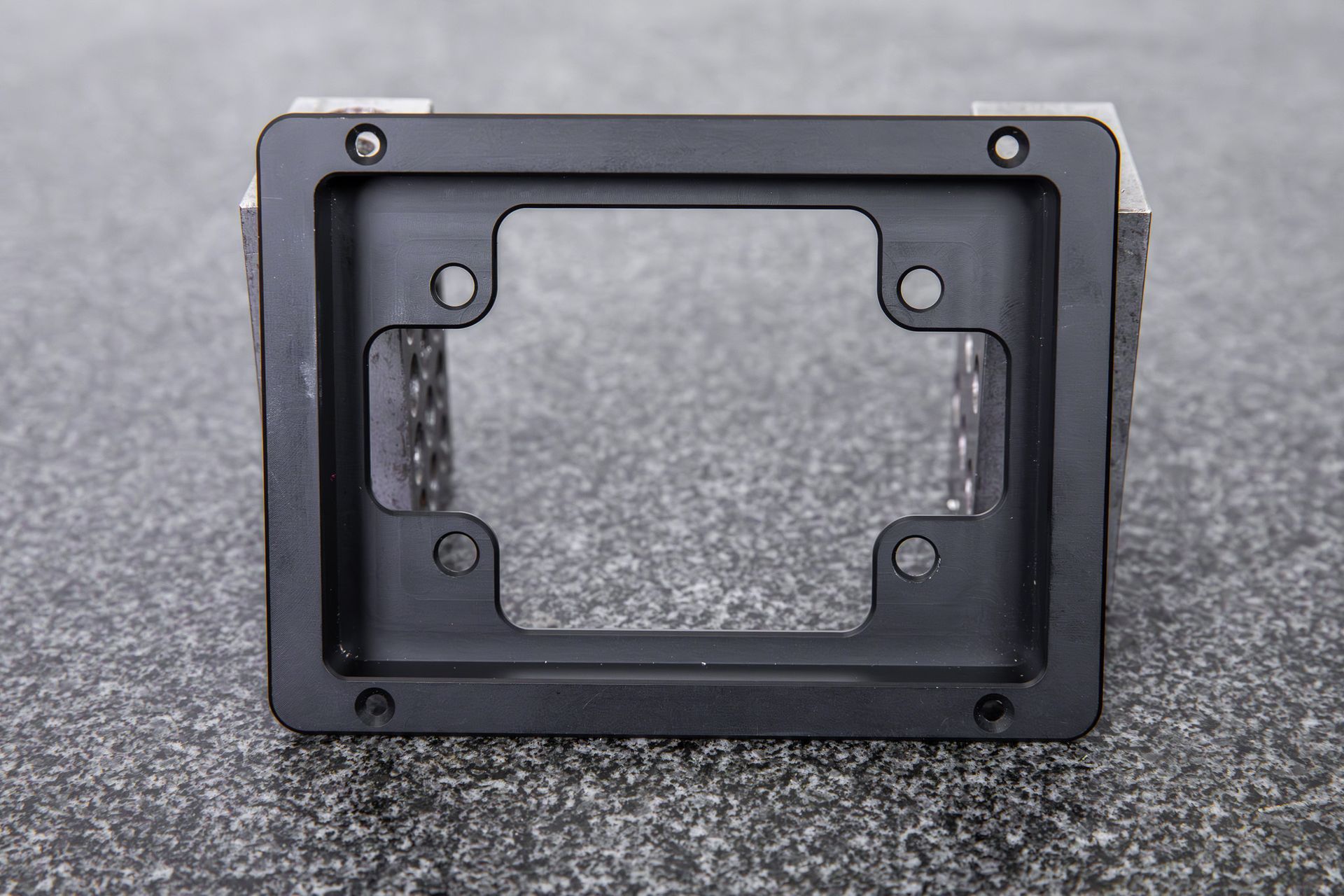A black billet dash mount bezel made by Precision Metal Craft for a 15-button key pad mount from Grayhill or Racegrade.
