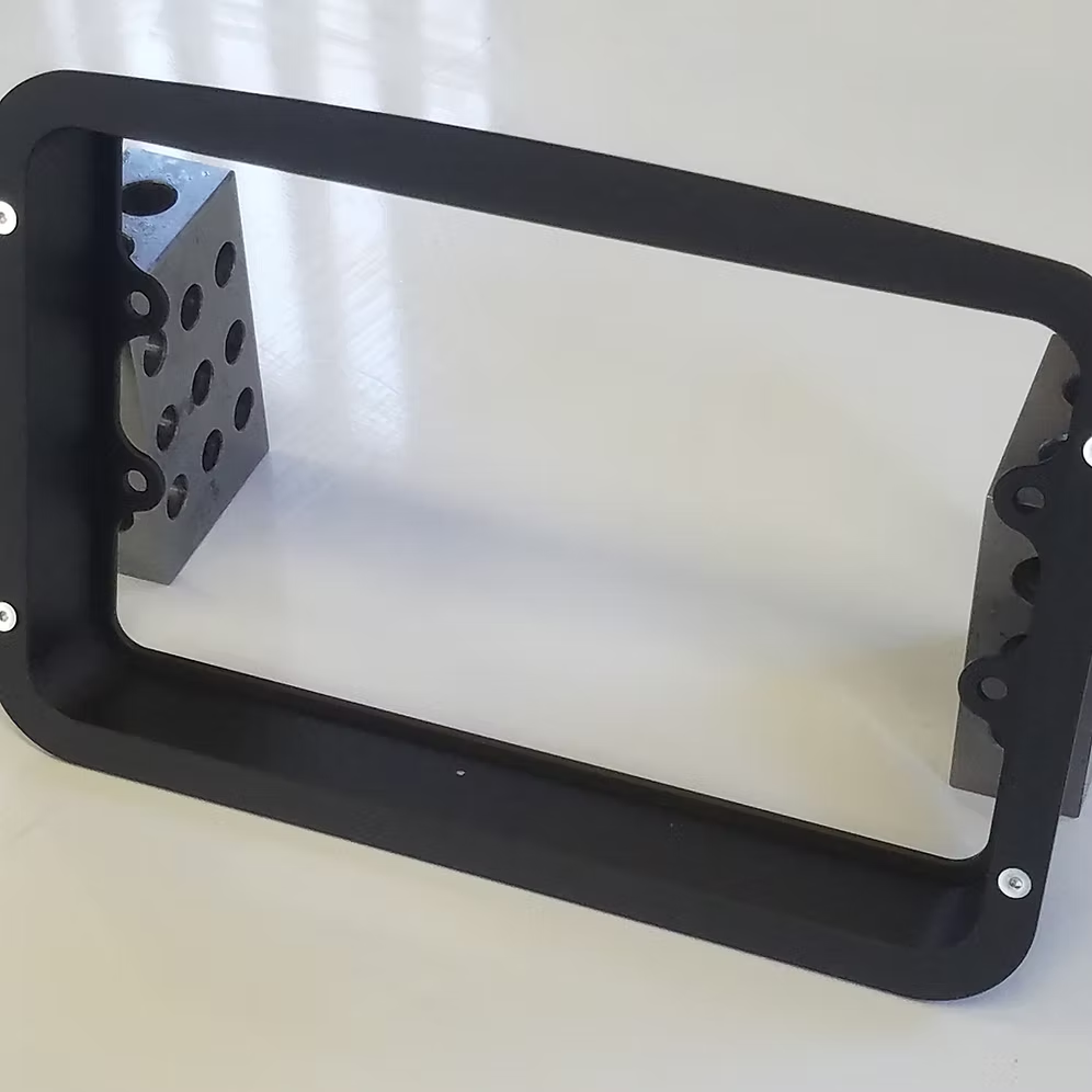 A black billet dash mount bezel made by Precision Metal Craft for a Holley EFI.