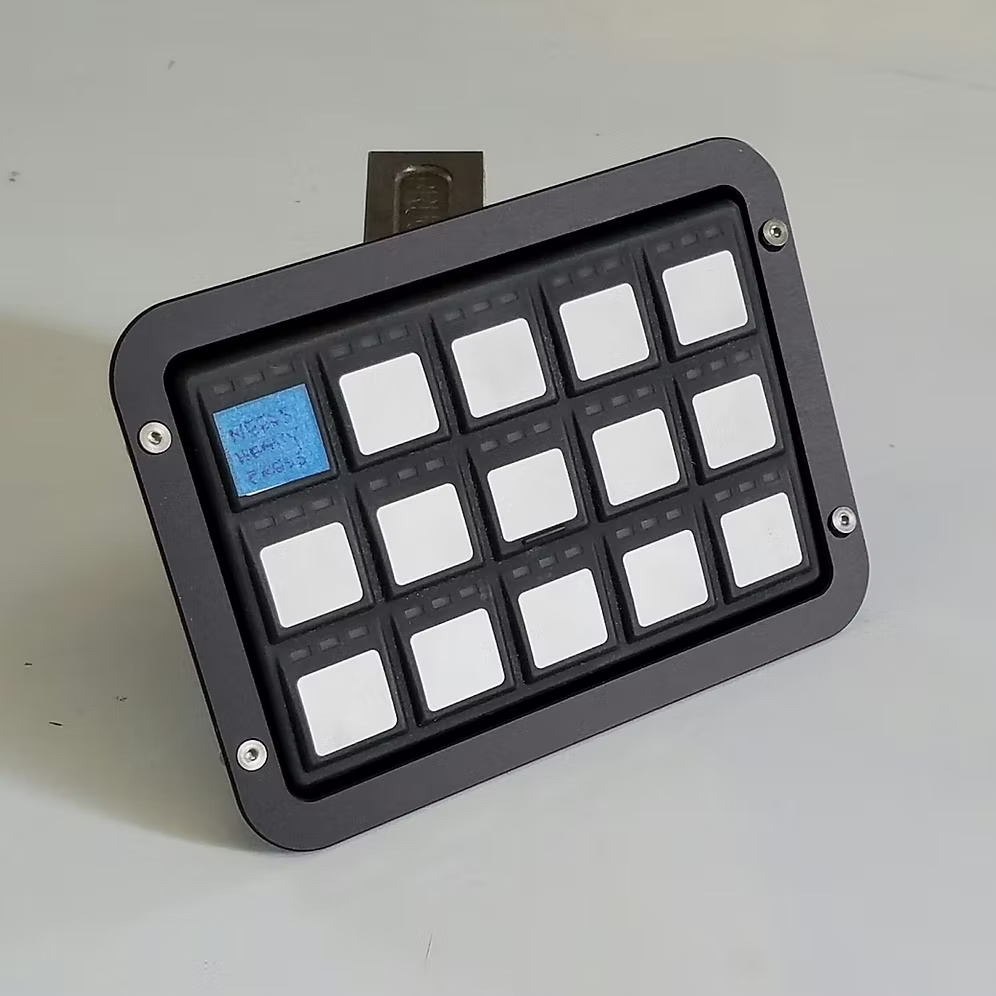 A black billet dash mount bezel made by Precision Metal Craft for a 15-button key pad mount from Grayhill or Racegrade.