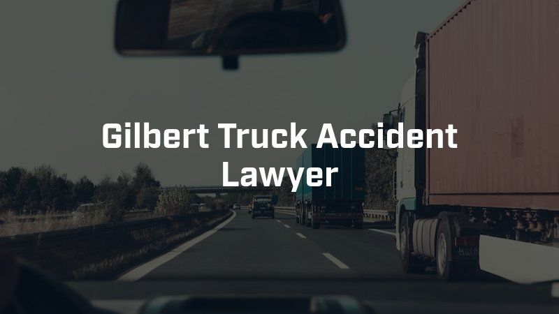 A truck is driving down a highway with the words gilbert truck accident lawyer below it.