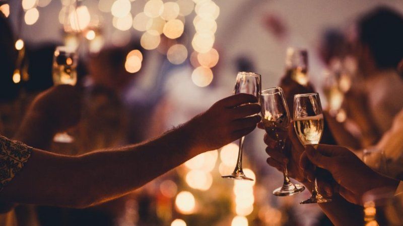 A group of people are toasting with champagne glasses at a party.