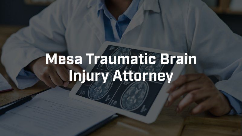 A mesa traumatic brain injury attorney is holding a tablet with a picture of a brain on it.