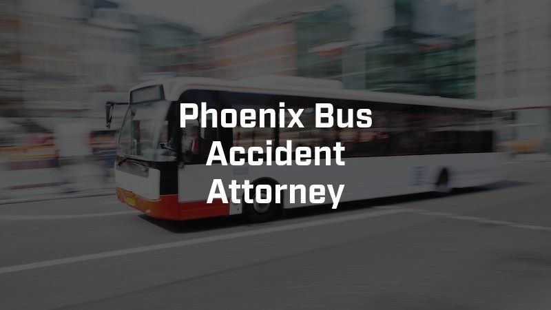 A white bus is driving down a city street.