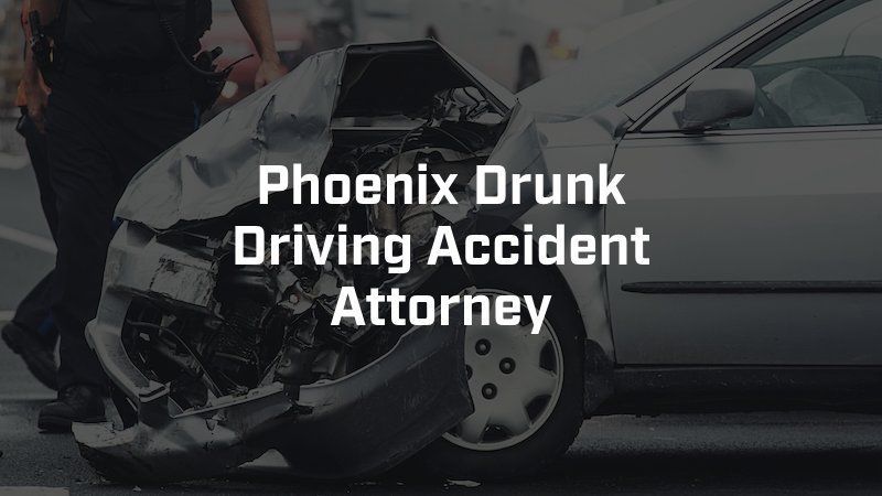 A phoenix drunk driving accident attorney is standing next to a wrecked car.