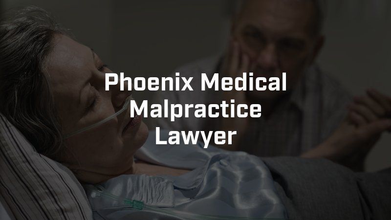 A woman is laying in a hospital bed with an oxygen mask on her face.