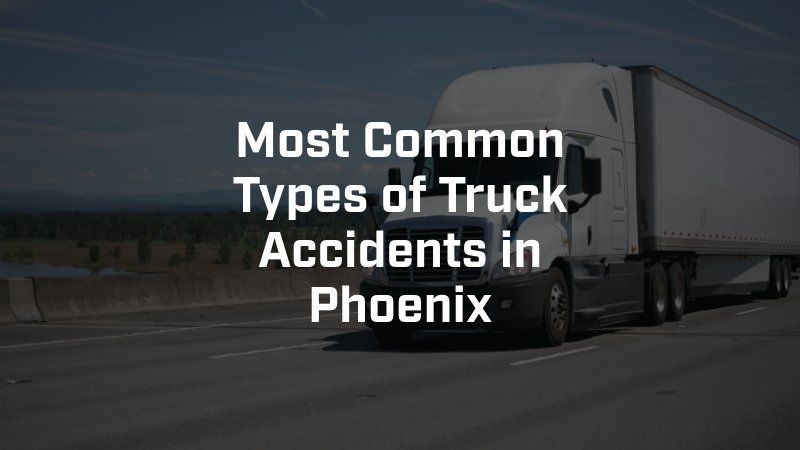 A white semi truck is driving down a highway.