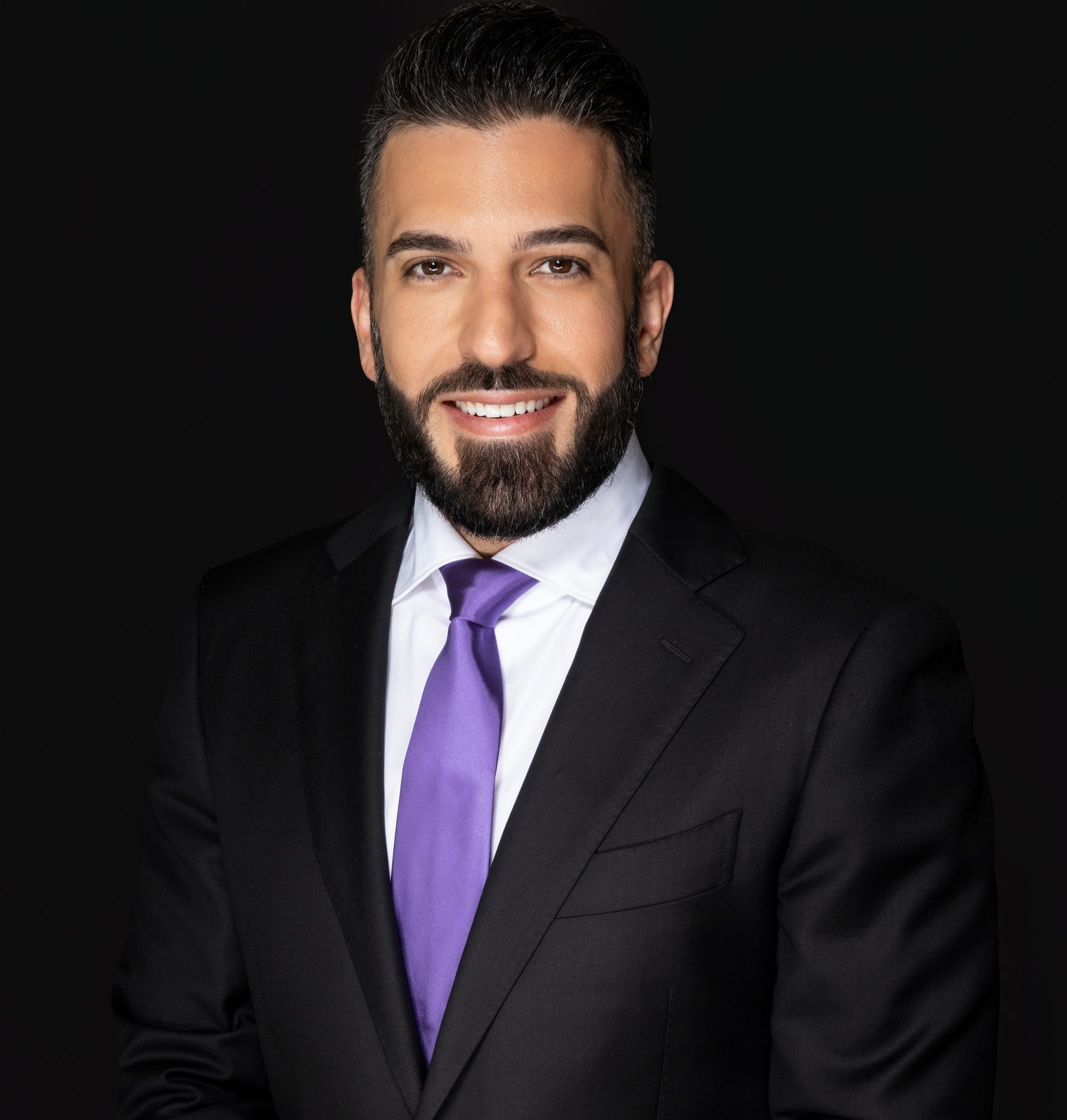 A man with a beard wearing a suit and tie