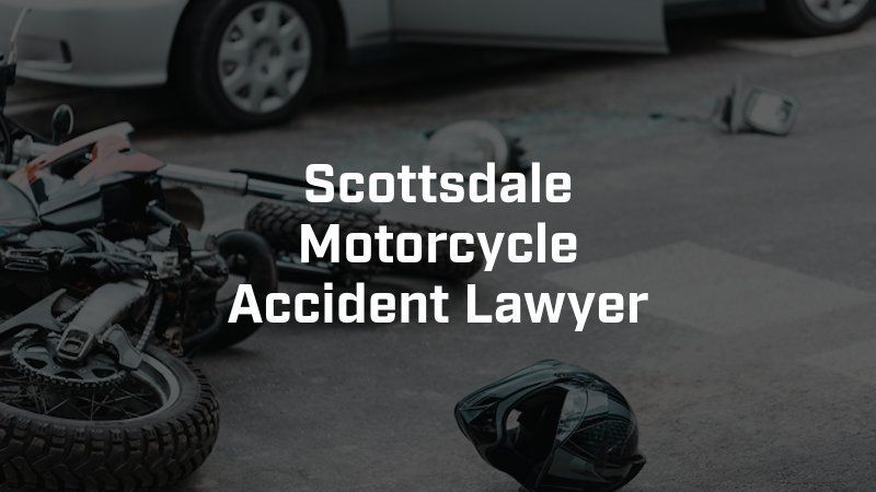 A motorcycle accident with a car and a helmet on the ground.