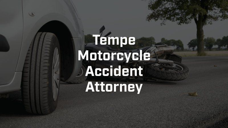 A car and a motorcycle are on the side of the road.