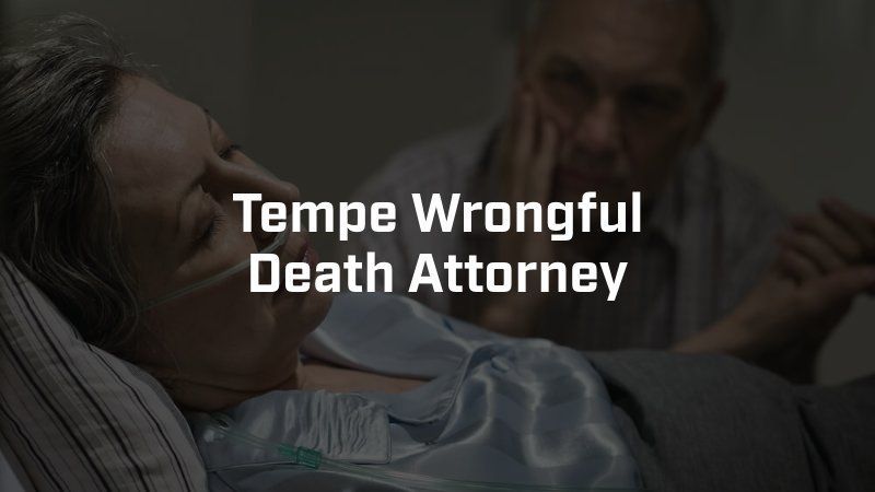 A woman is laying in a hospital bed while a man looks on ..